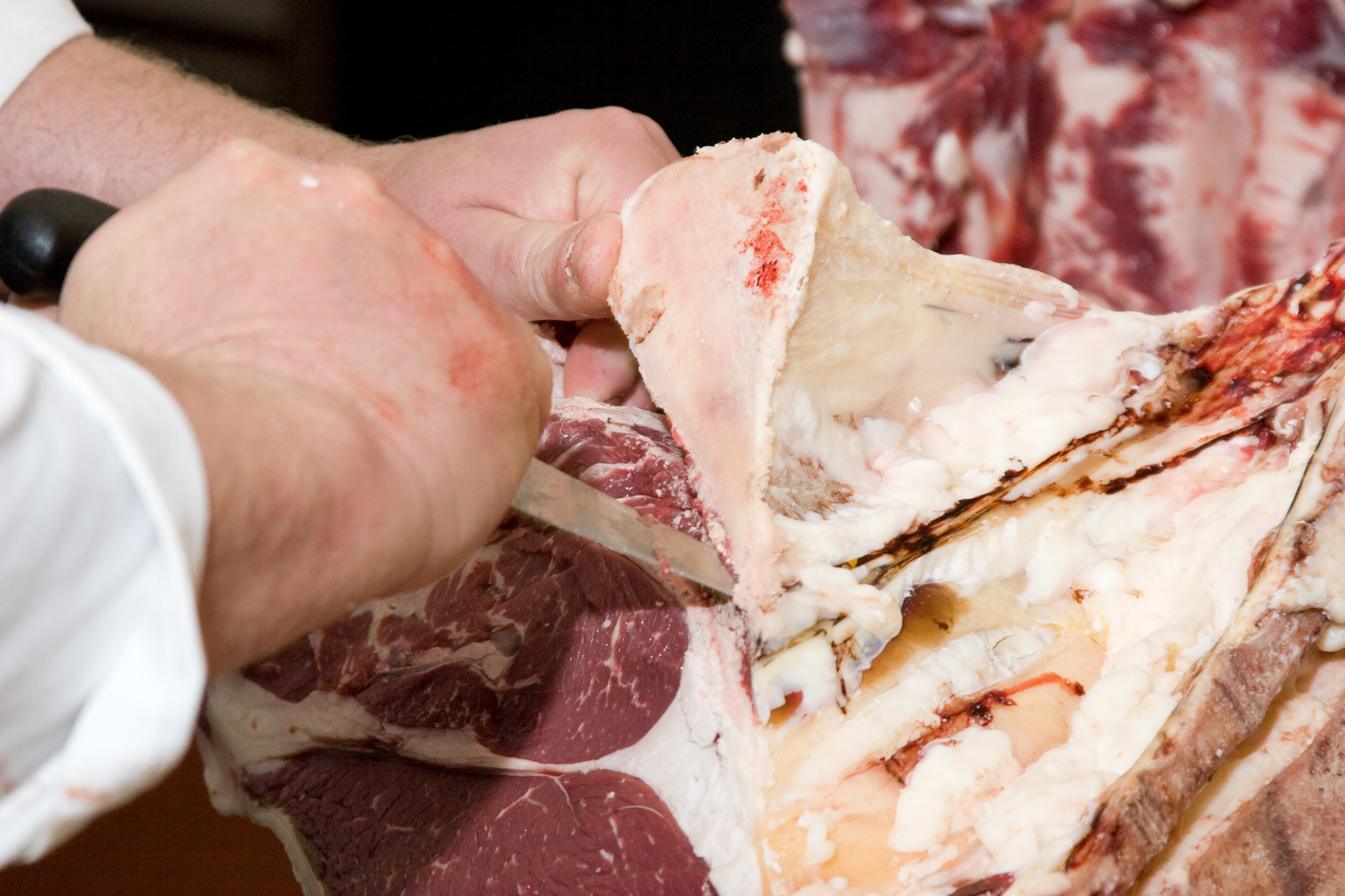 Butcher hands cutting meat 2